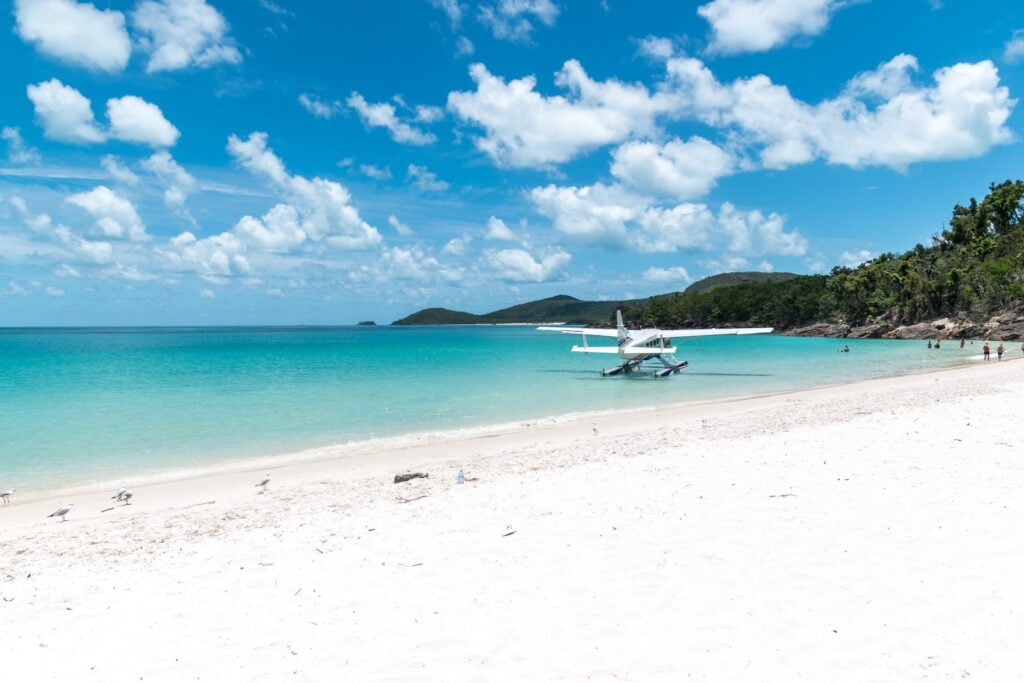 Find the best time to visit australia as a backpacker 10 White and blue boat on sea during daytime - whitsunday backpackers - best time of year to go backpacking in australia