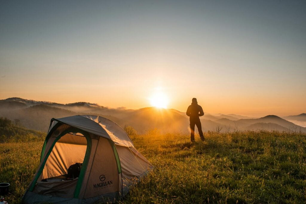 Our 6 epic backpacker camping & hiking trips you won't regret 7 Silhouette of backpacker Standing Near Camping Tent ready for a hike