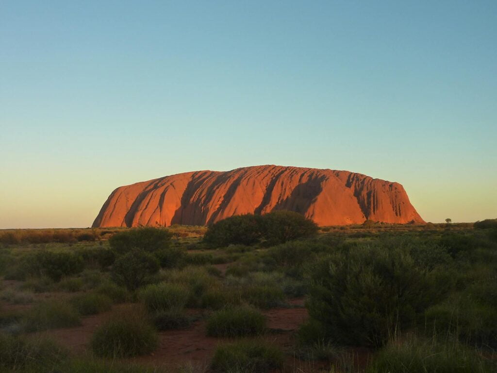 Our 6 epic backpacker camping & hiking trips you won't regret 2 Backpackers camping and hiking at Uluru Rock Formation in Central Australia