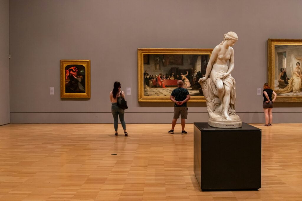 The best Art Galleries & Museums for Backpackers in Melbourne 1 backpackers exploring NGV melbourne standing near white statue